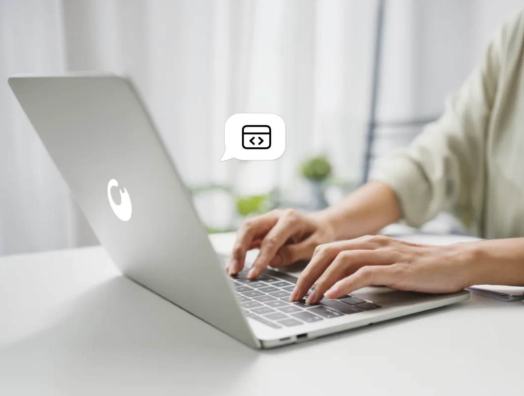 Person coding on a laptop with the Gatblac logo